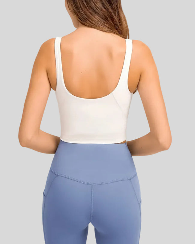 Back view of PureForm white sports bra with smooth wide straps and cropped fit