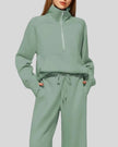 Close-up of Athlesi PureMotion Half-Zip Lounge Set showing half-zip neckline and fabric texture in green