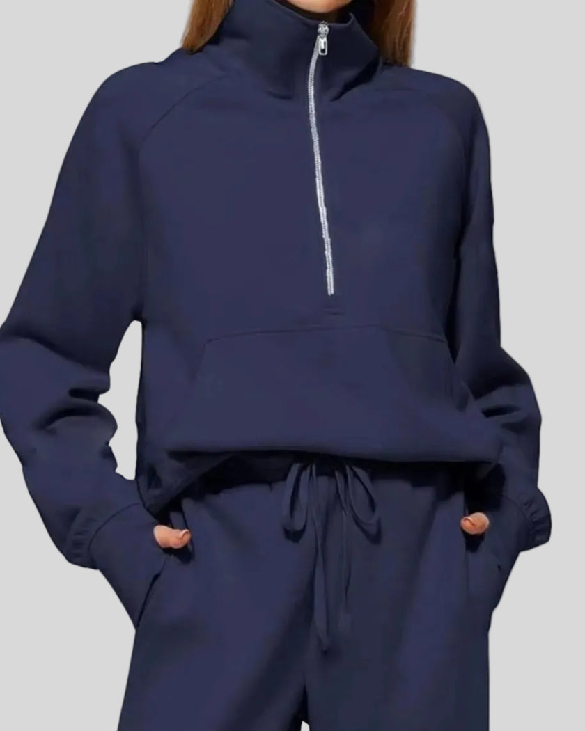 Close-up of Athlesi PureMotion Half-Zip Lounge Set showing half-zip neckline and fabric texture in navy blue
