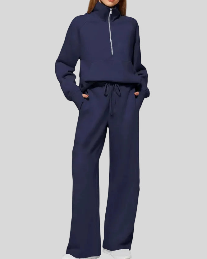 Woman wearing Athlesi PureMotion Half-Zip Lounge Set in navy, front full body view
