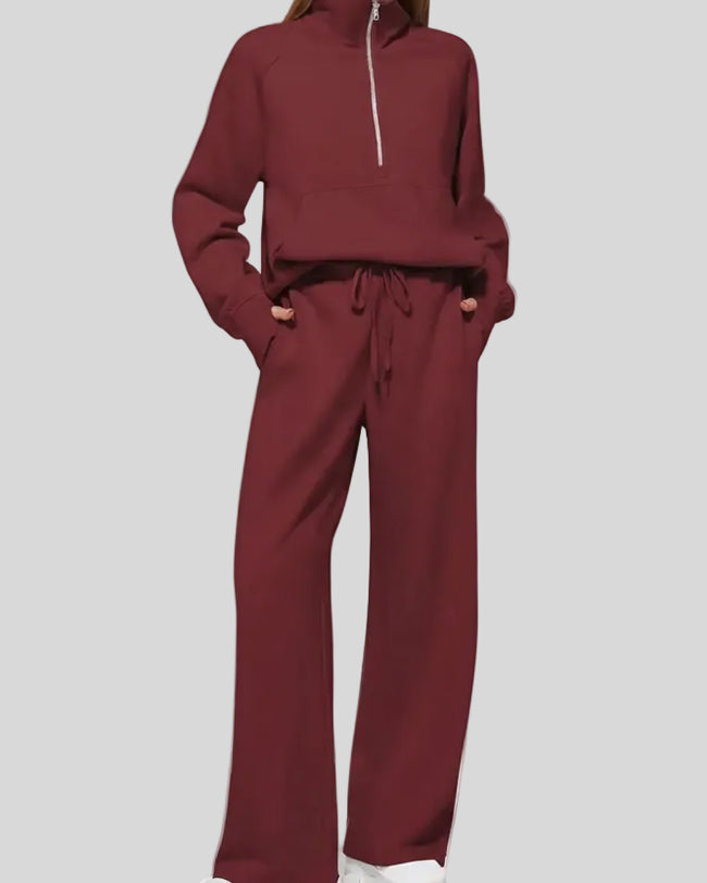 Woman wearing Athlesi PureMotion Half-Zip Lounge Set in wine red, front full body view