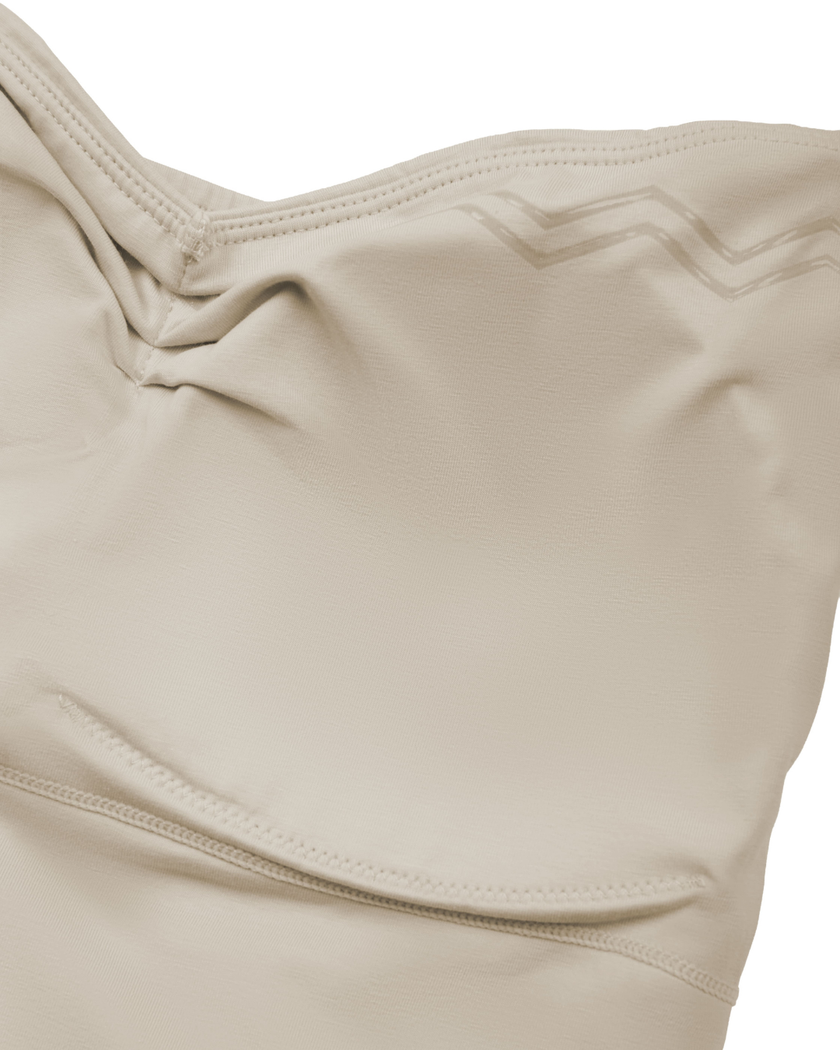 Interior chest padding detail of the Athlesi QuietForm Ruched Tube Top in Pale Khaki