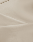 Close-up of the soft stretch cotton fabric on the Athlesi QuietForm Ruched Tube Top in Pale Khaki
