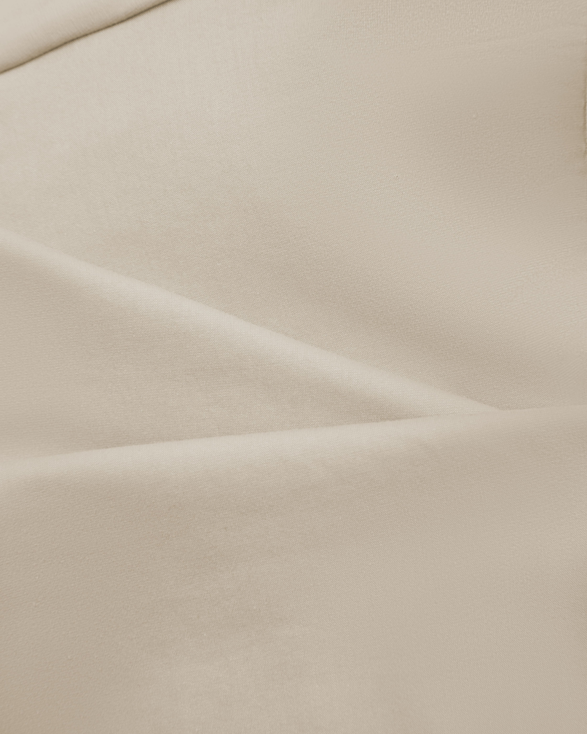 Close-up of the soft stretch cotton fabric on the Athlesi QuietForm Ruched Tube Top in Pale Khaki