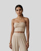Model wearing the Athlesi QuietForm Ruched Tube Top in Pale Khaki, mid-body front view