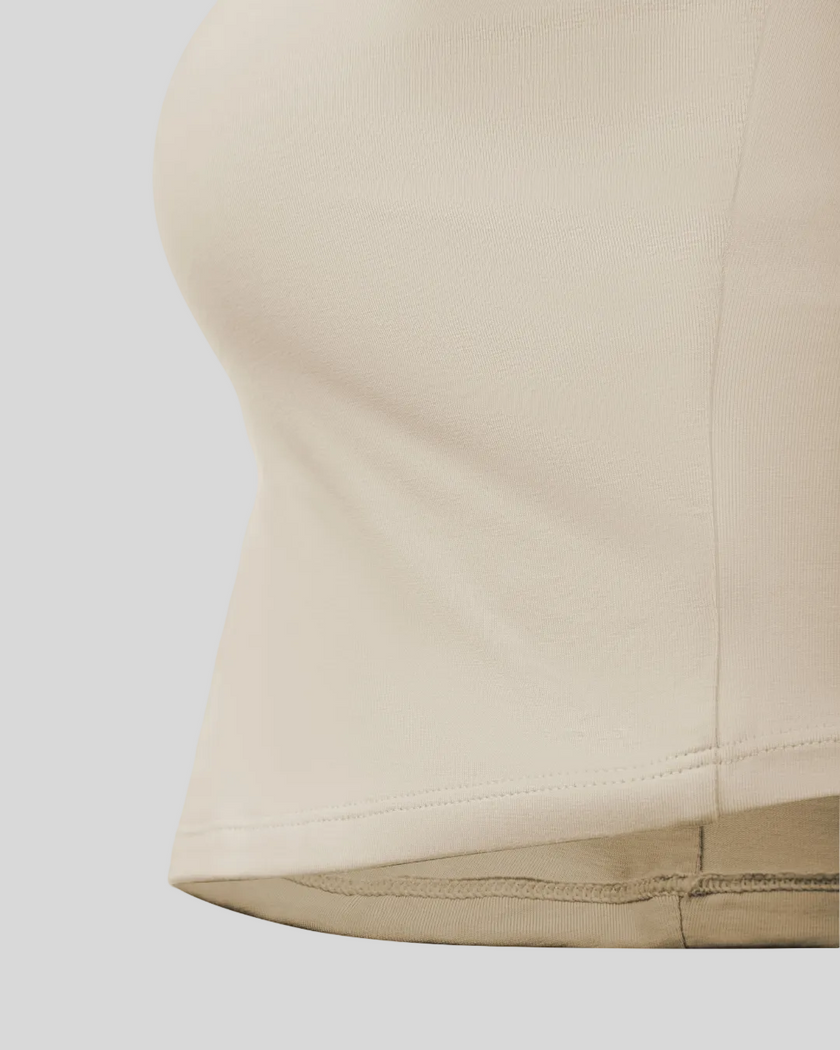 Close-up of the straight waist hem on the Athlesi QuietForm Ruched Tube Top in Pale Khaki