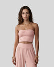 Model wearing the Athlesi QuietForm Ruched Tube Top in Pink, mid-body front view.