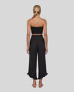 Model wearing Athlesi QuietForm Wide Leg Pants in Black, back view highlighting the wide waistband and relaxed silhouette