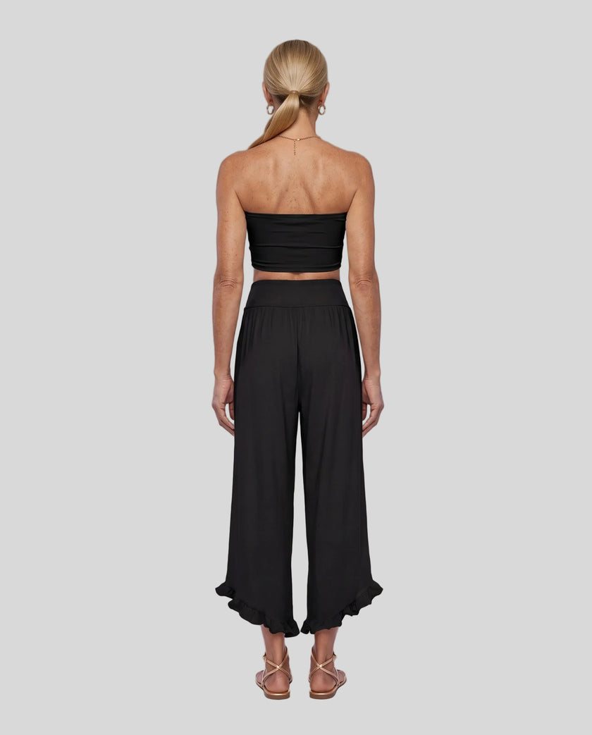 Model wearing Athlesi QuietForm Wide Leg Pants in Black, back view highlighting the wide waistband and relaxed silhouette