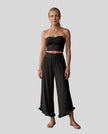 Model wearing Athlesi QuietForm Wide Leg Pants in Black, front view showing the relaxed wide-leg fit and fluid drape