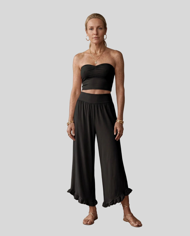 Model wearing Athlesi QuietForm Wide Leg Pants in Black, front view showing the relaxed wide-leg fit and fluid drape