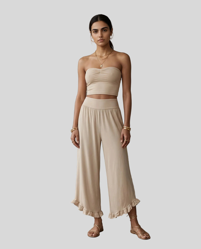 Model wearing Athlesi QuietForm Wide Leg Pants in Pale Khaki, front view showing the relaxed wide-leg fit and fluid drape