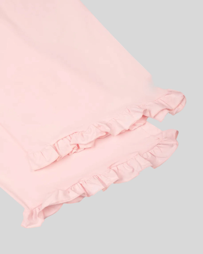 Close-up of the feminine ruffle hem on the Athlesi QuietForm Wide Leg Pants in Pink