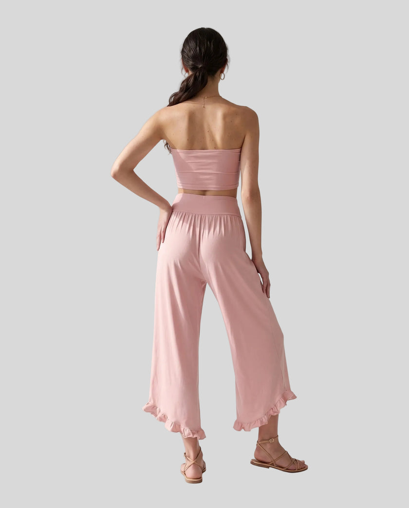 Model wearing Athlesi QuietForm Wide Leg Pants in Pink, back view highlighting the wide waistband and relaxed silhouette