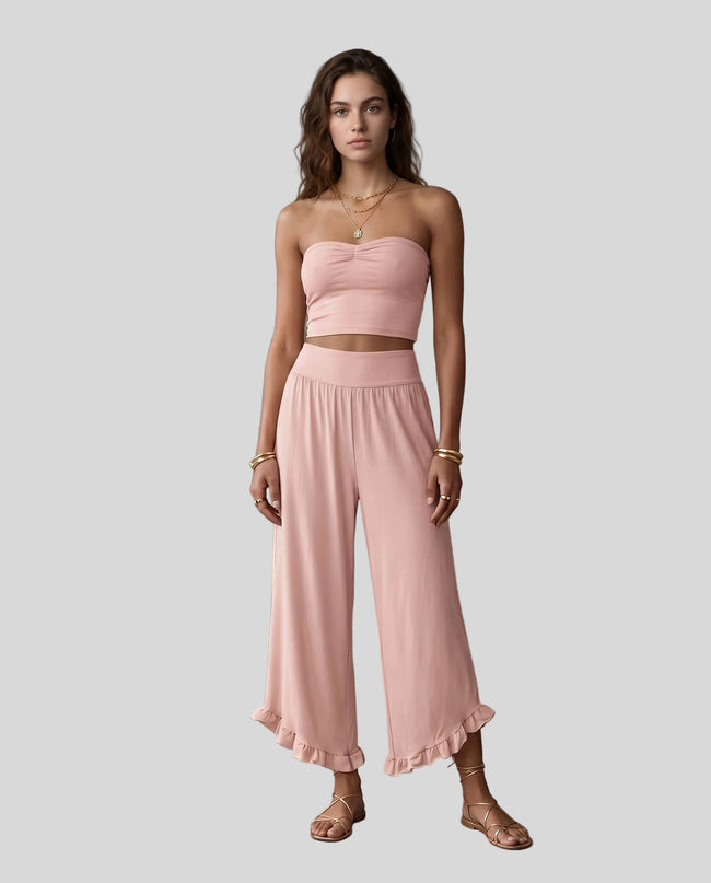 Model wearing Athlesi QuietForm Wide Leg Pants in Pink, front view showing the relaxed wide-leg fit and fluid drape