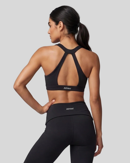 Mid body back view showing the open-back design of Sculpt Halter Sports Bra in black