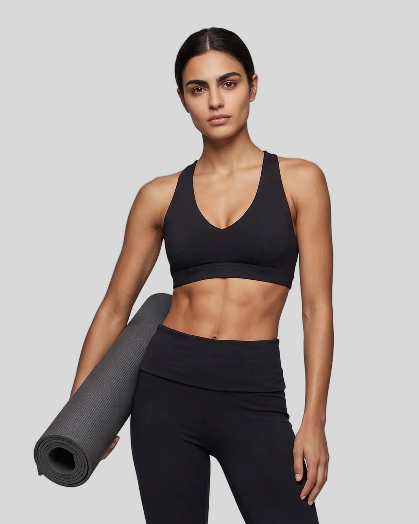 Mid body front view of woman wearing Sculpt Halter Sports Bra in black
