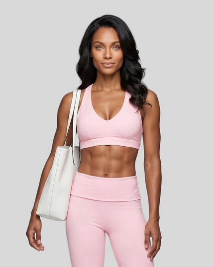 Mid body front view of woman wearing Sculpt Halter Sports Bra in pink