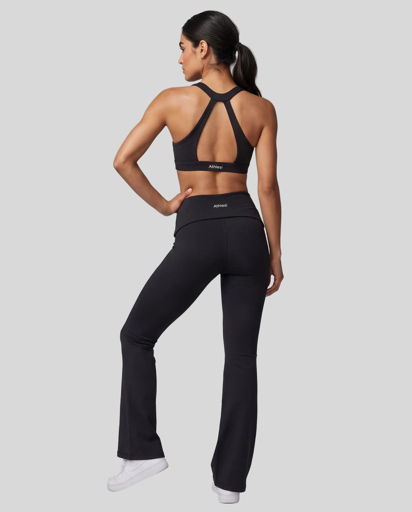 Back view of a woman modeling a black Athlesi activewear set consisting of a Sculpt Yoga Pants and matching Sculpt Halter Sports Bra