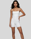 Model wearing Athlesi square neck romper in white mid body front