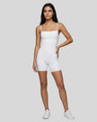 Model wearing Athlesi square neck romper in white full body front