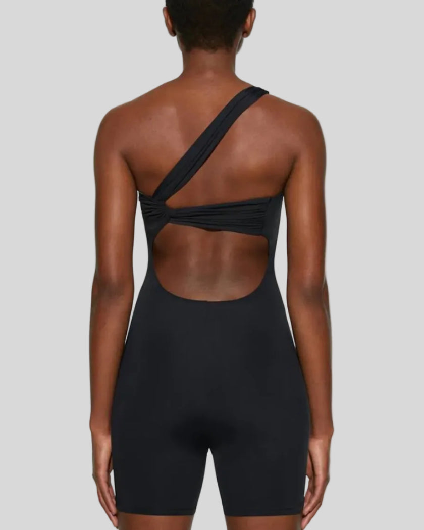 Back mid body view showing open back detail of Athlesi SculptLine one-shoulder active romper in black