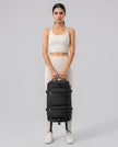 Model carrying ShiftForm Carry Pack in black styled for gym and everyday movements