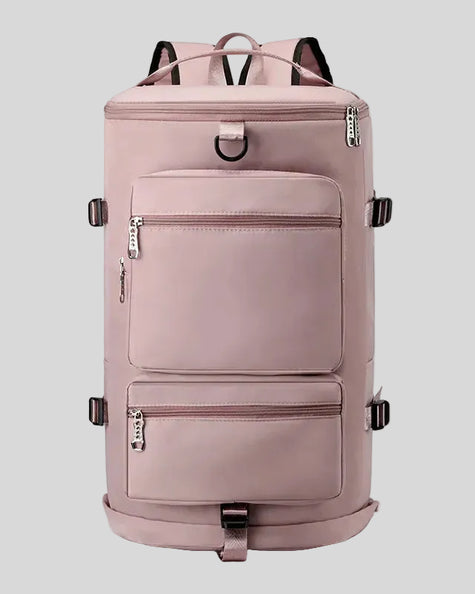 ShiftForm Carry Pack in dusty pink shown in vertical position with structured multi-pocket design