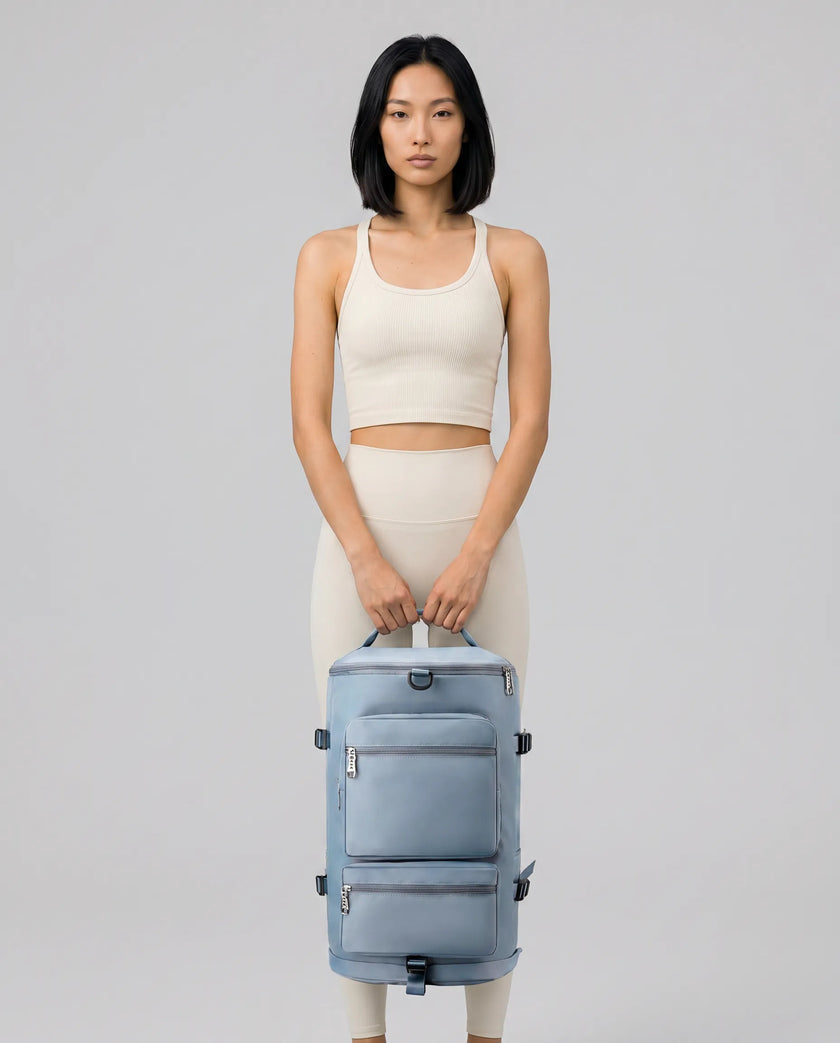 Model carrying ShiftForm Carry Pack in light blue styled for gym and everyday movements