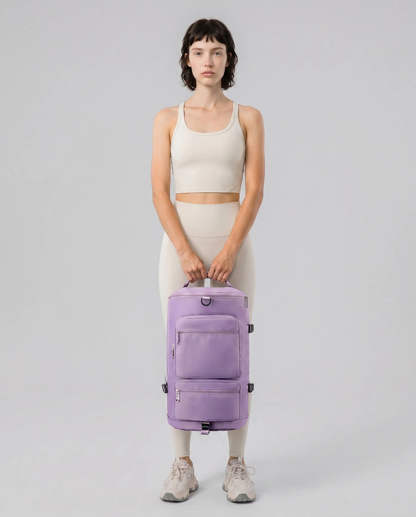 Model carrying ShiftForm Carry Pack in lilac styled for gym and everyday movements