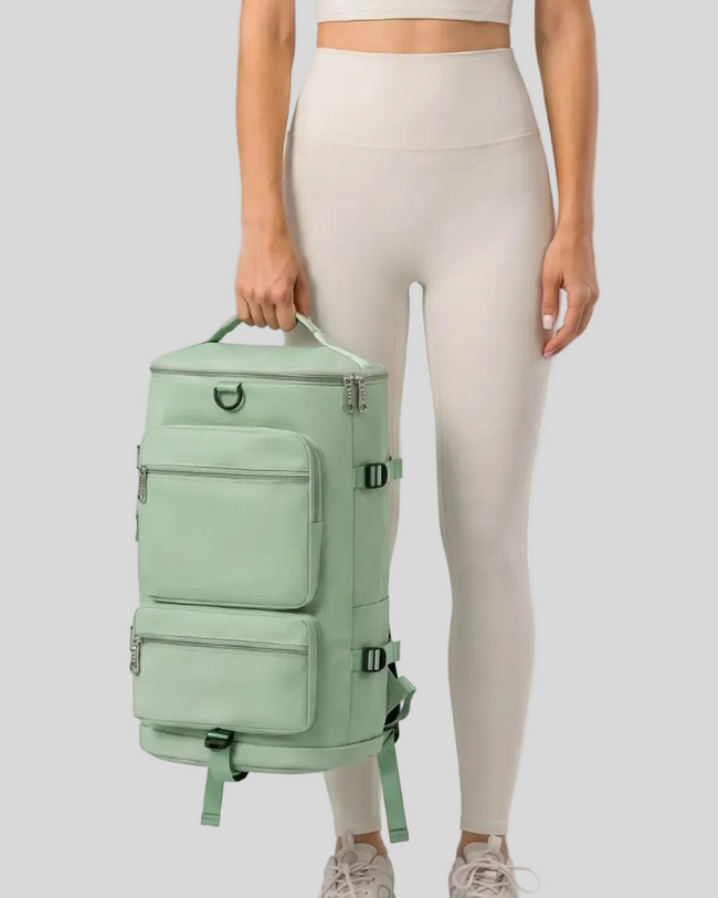 Model holding a neon green ShiftForm Carry Pack in a neutral studio setting