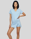 Woman wearing the SkyEase Lounge Set in pastel blue front view with relaxed V-neck top and matching skort