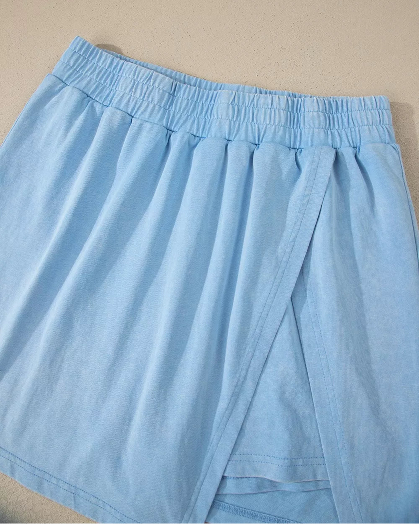 Front flatlay of the pastel blue skort from the SkyEase Lounge Set with relaxed overlap design