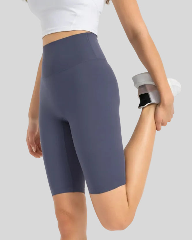 Angled front view showing smooth fit and biker length in dusty blue