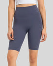 Front view of Athlesi SmoothForm Seamless Biker Short in dusty blue with wide waistband