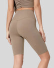 Back view of mocha Athlesi biker short with wide seamless 