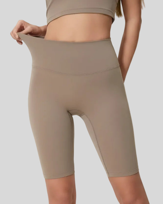 Angled front view showing smooth fit and biker length in mocha