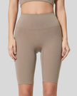Front view of Athlesi SmoothForm Seamless Biker Short in mocha with wide waistband