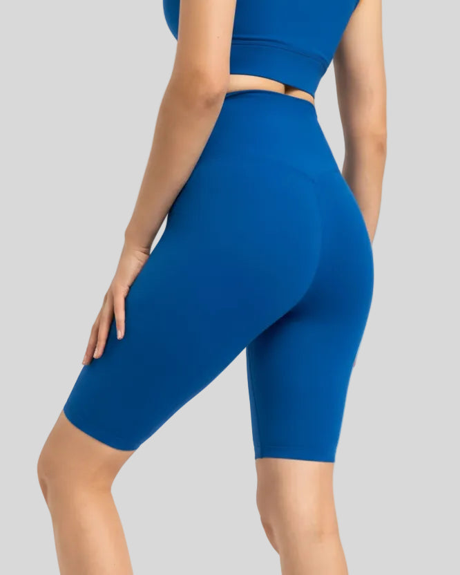Back view of royal blue Athlesi biker short with wide seamless 