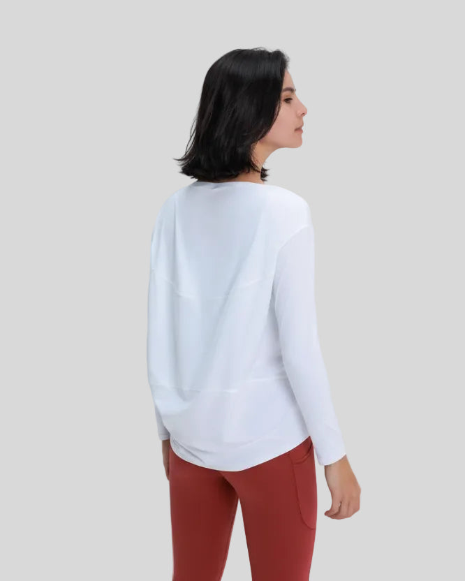 Angled back view of Athlesi SoftFlow relaxed long sleeve active top in white