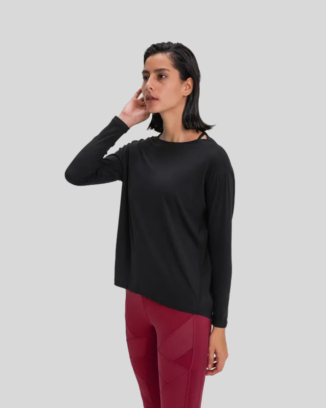 Side view of Athlesi SoftFlow relaxed long sleeve active top in black