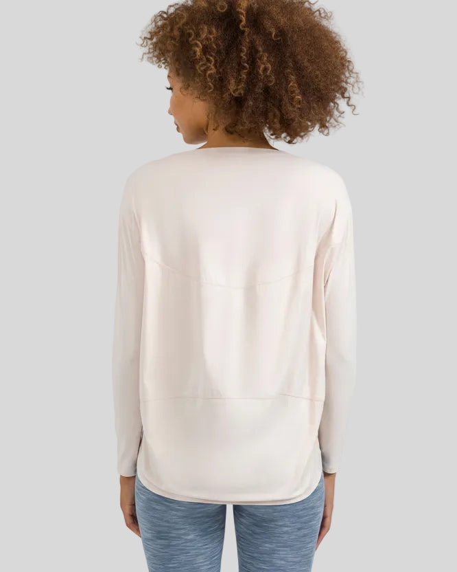Back view of Athlesi SoftFlow relaxed long sleeve top in cream