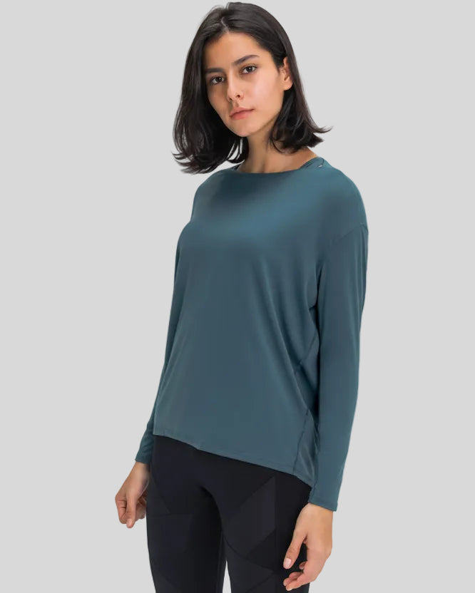 Side view of Athlesi SoftFlow relaxed long sleeve active top in deep teal