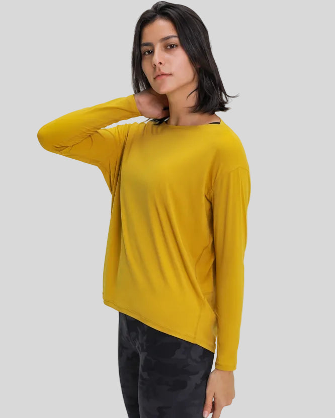 Side view of Athlesi SoftFlow relaxed long sleeve active top in mustard