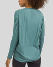 Back view of Athlesi SoftFlow relaxed long sleeve top in teal