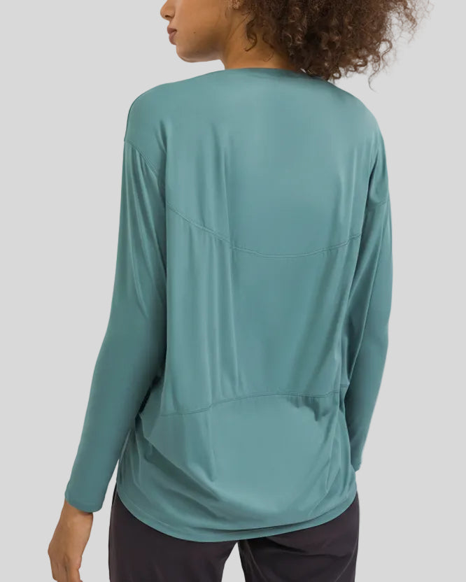 Back view of Athlesi SoftFlow relaxed long sleeve top in teal