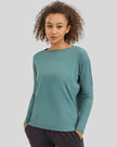 Athlesi SoftFlow relaxed long sleeve active top in teal, front view
