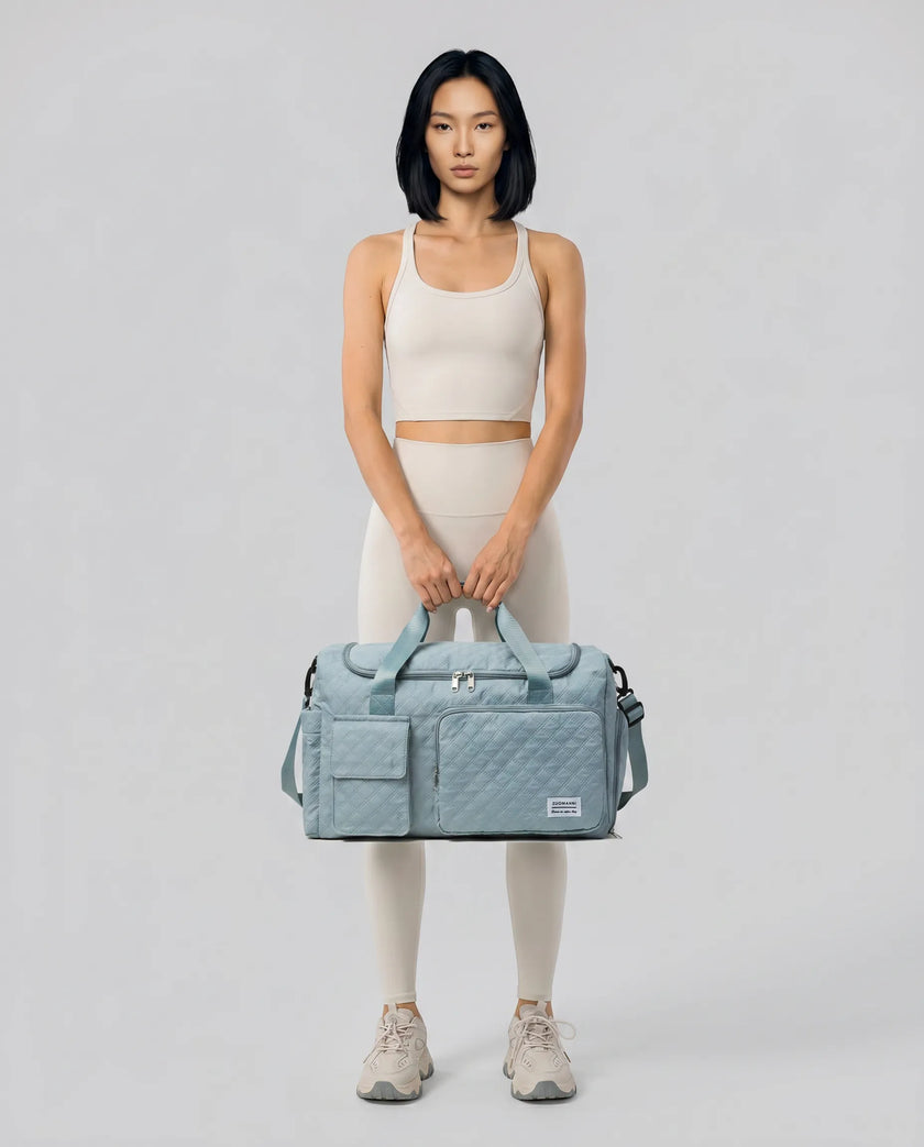 Model holding SoftForm Carry Bag in air force blue styled for everyday and gym movement