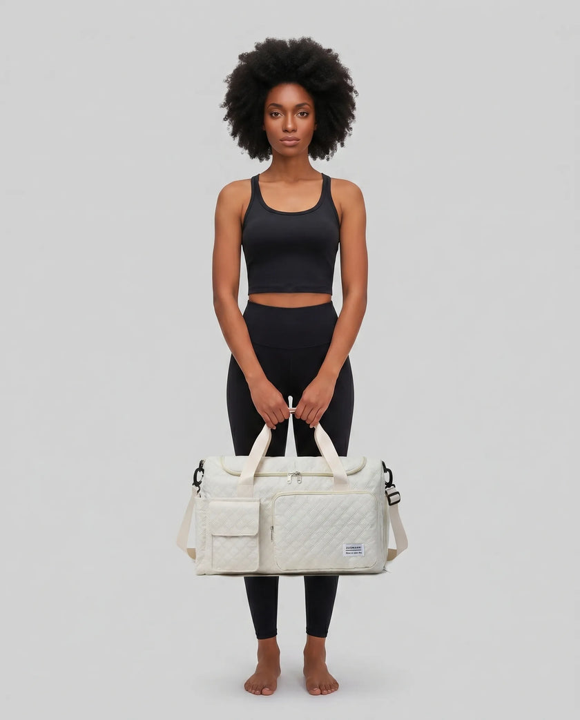Model holding SoftForm Carry Bag in beige styled for everyday and gym movement