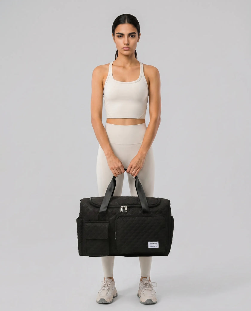 Model holding SoftForm Carry Bag in black styled for everyday and gym movement